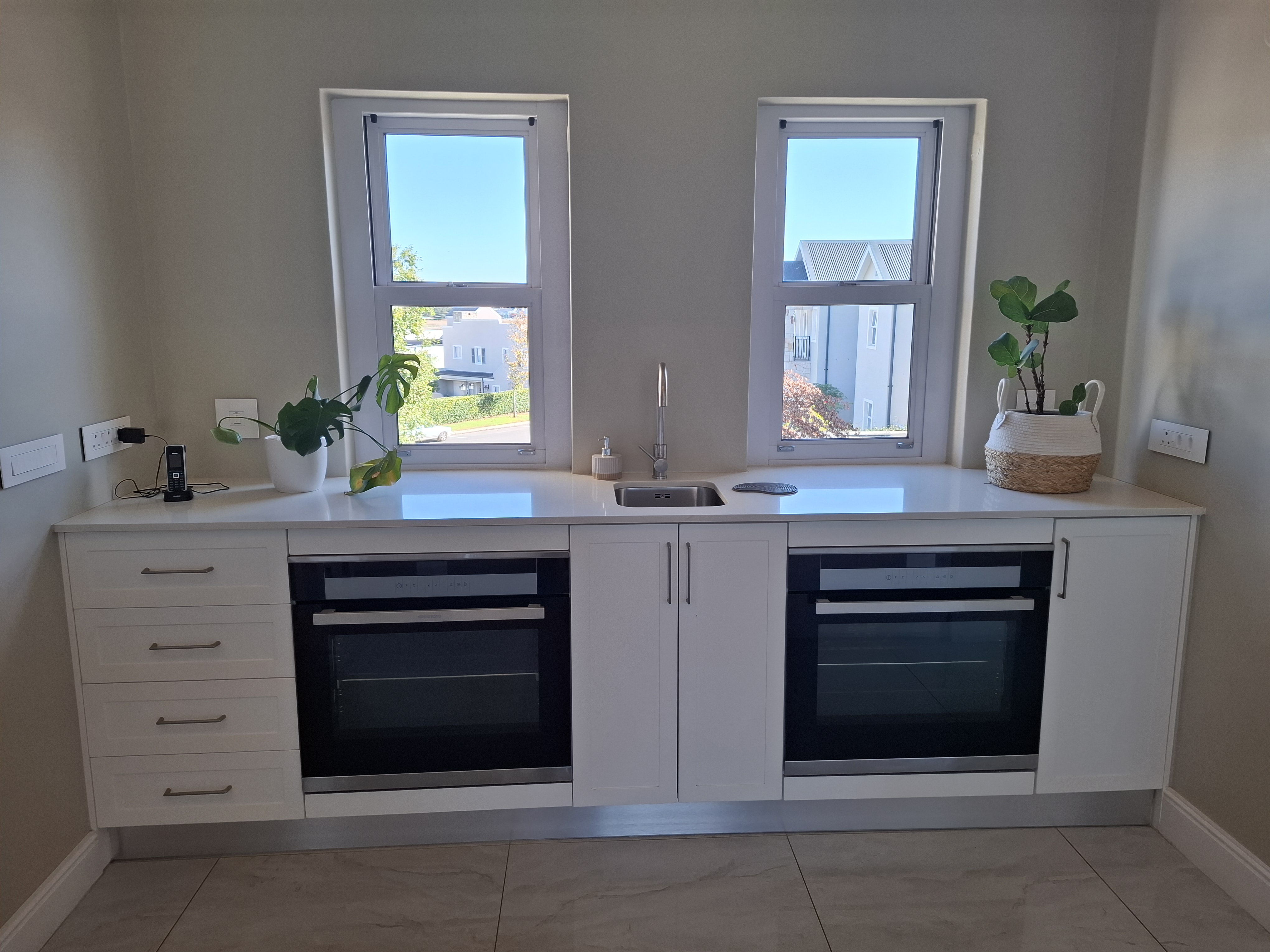 White Double-Oven Kitchen by Cutting Edge Carpenters